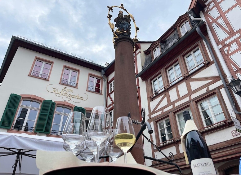 A wine glass, a bottle of wine, and a building with a sign reading 'Zum Kirschengarten.' 2
