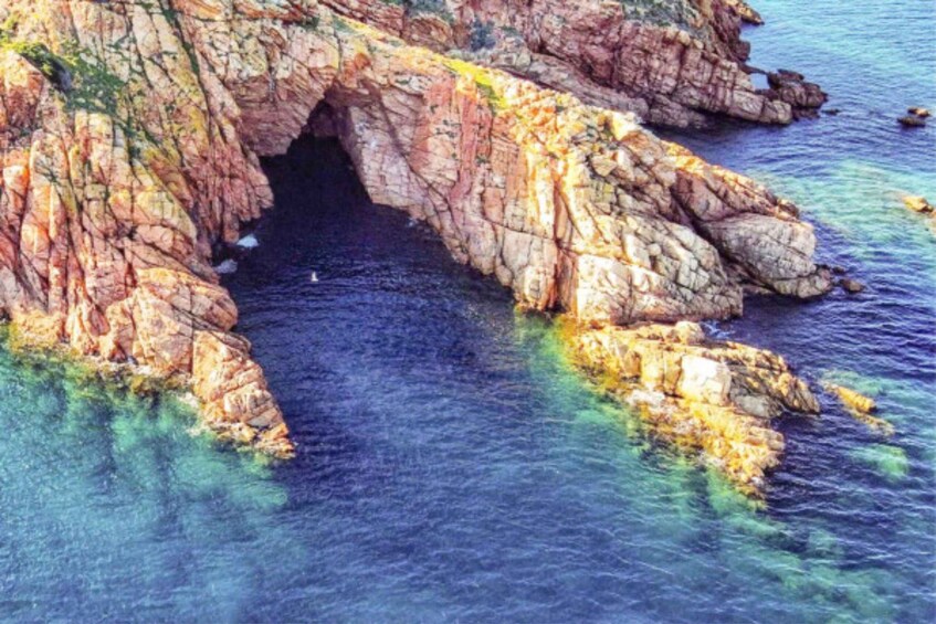 A rocky coastline with a natural arch formation. 3