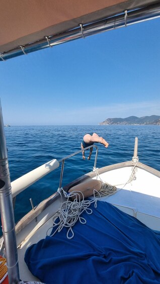 A person diving into the water from a boat. 2