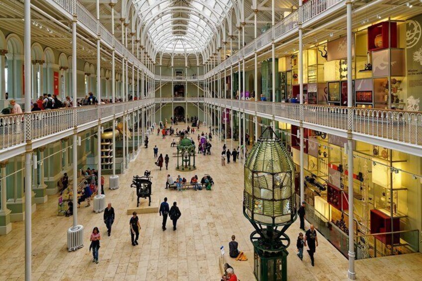A multi-level shopping mall with a central atrium, glass railings, and various stores. 2