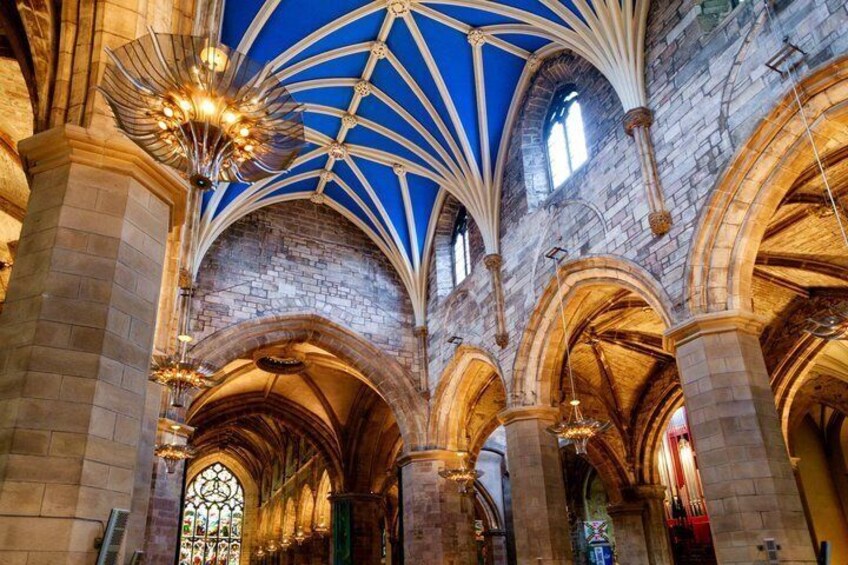 A cathedral interior with arched ceilings, stained glass windows, and stone columns. 3