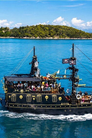 A Black Rose ship with passengers, sailing on a clear day. 1