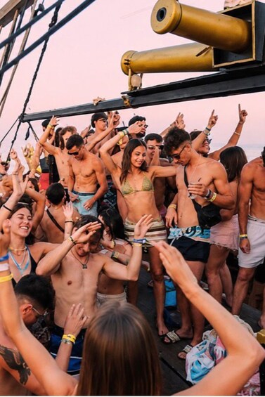 A group of people dancing on a boat deck. 2