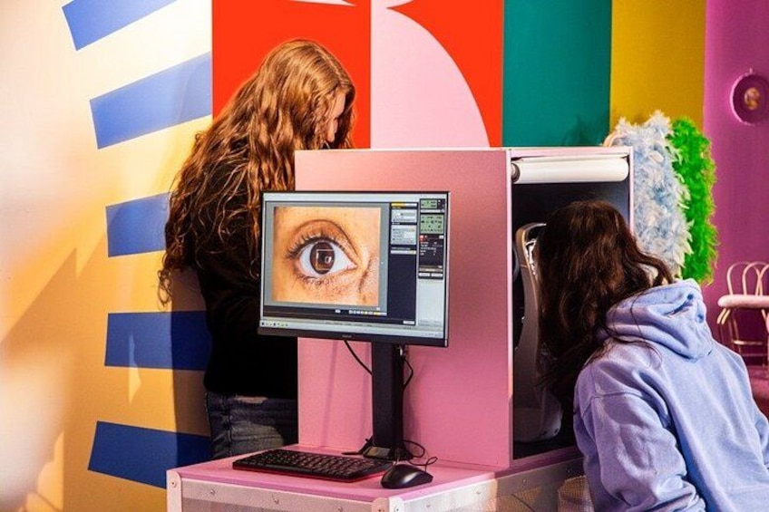 A person using a computer with a screen displaying an eye. 1