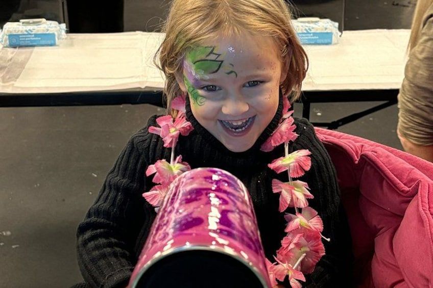 A person holding a pink container with a flower. 3