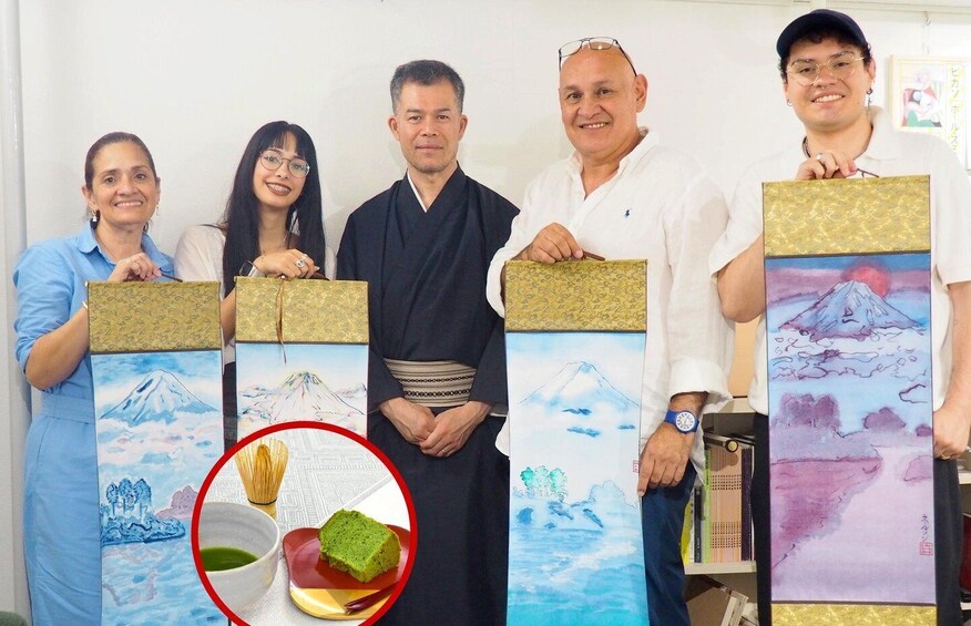 A group of people holding framed artworks with mountain landscapes. 1