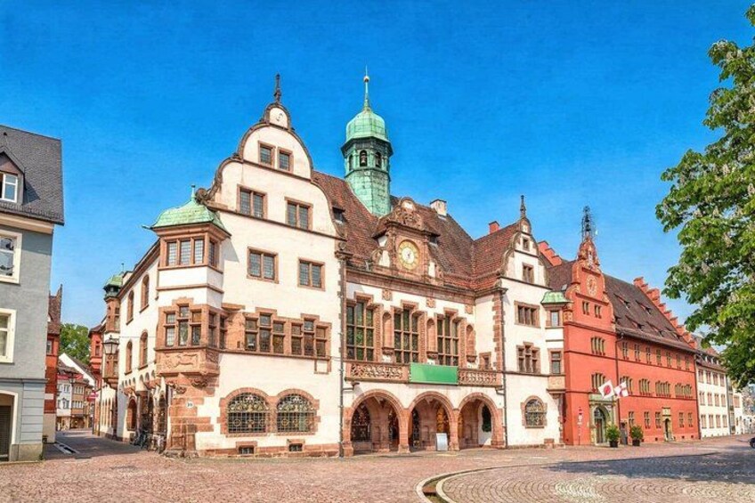 A historic building with a clock tower and arched windows. 5
