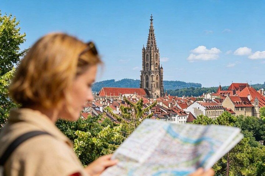 A person holding a map, overlooking a cityscape with a prominent church tower. 3