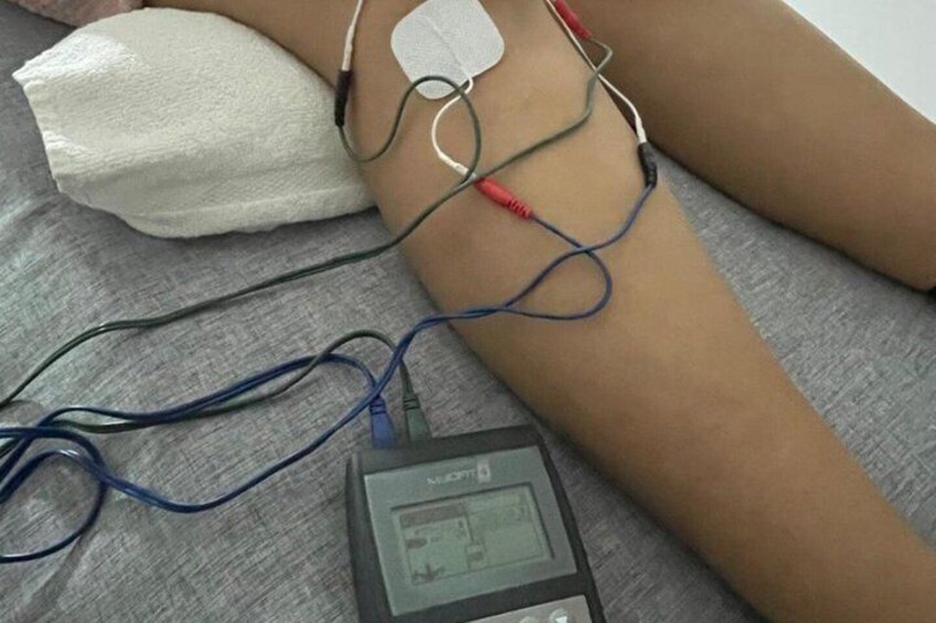 A medical device connected to a patient's arm, with wires and a monitor. 5
