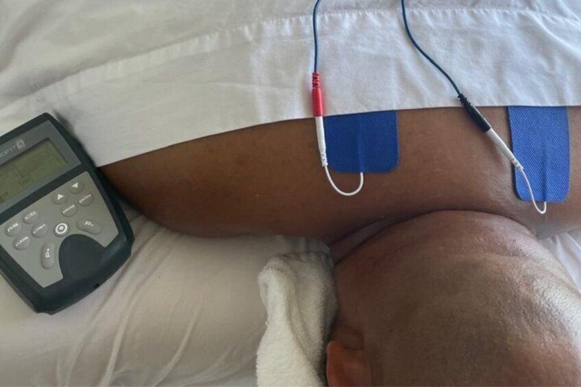 A person lying in bed with a pulse oximeter and electrodes attached to their finger and chest. 4