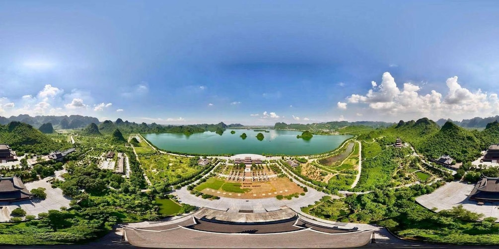 A traditional Chinese garden with a large pond, surrounded by lush greenery and classical architecture. 3