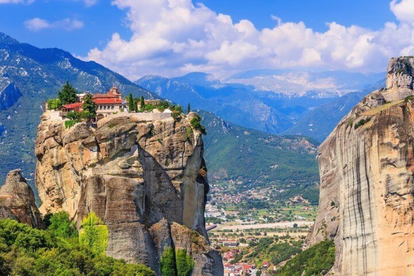 A monastery on a rocky cliff overlooking a valley. 3