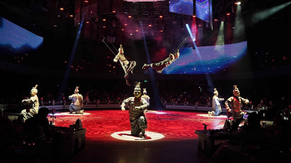 A traditional performance with acrobats on a stage. 2