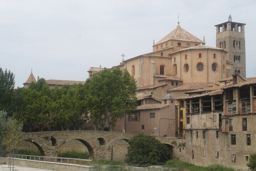A historic building with a bell tower and arches. 3