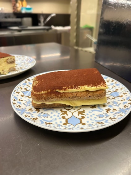 A slice of tiramisu on a decorative plate. 3