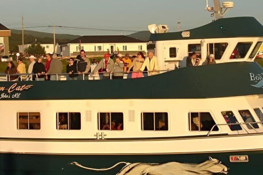 A boat with people on the deck, a name 'Bon-Cast' visible, and a 'H&H' logo on the side. 4