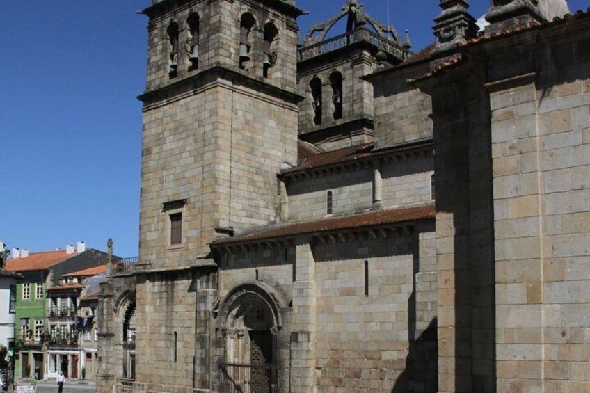 A historic stone building with a bell tower and arched entrance. 4