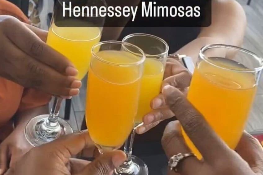 A group of people holding glasses of orange juice. 5