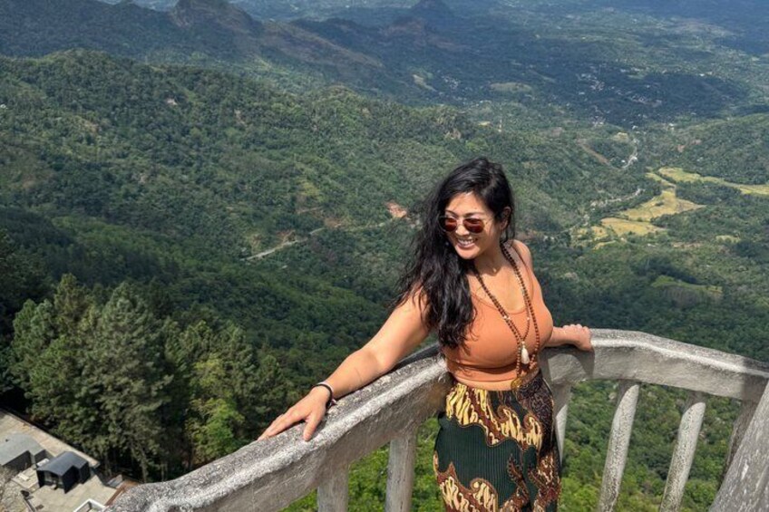 A person standing on a high vantage point overlooking a mountainous landscape. 2