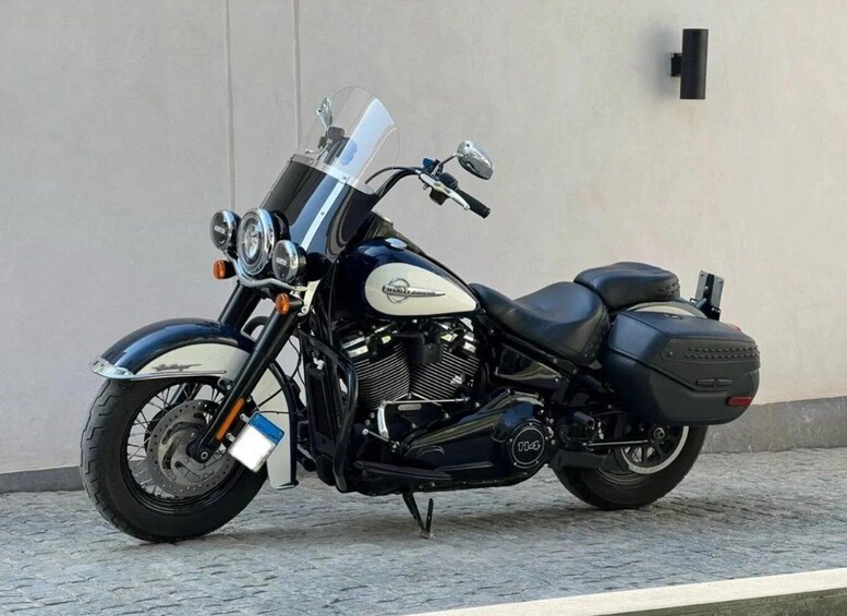 A black motorcycle with a windshield, chrome accents, and a license plate. 2