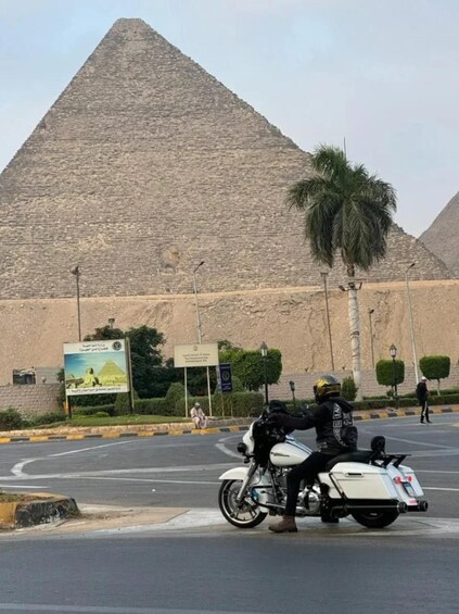 A pyramid, a motorcyclist, and a palm tree. 3