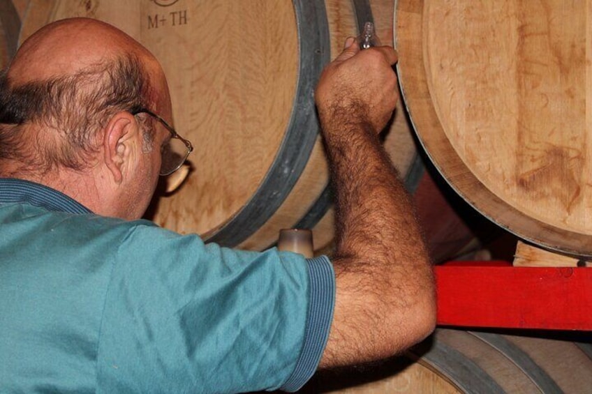 A person working with wooden barrels. 1