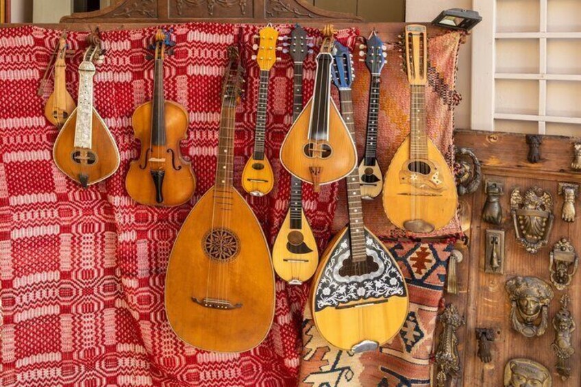 A collection of stringed instruments and decorative items on display. 4