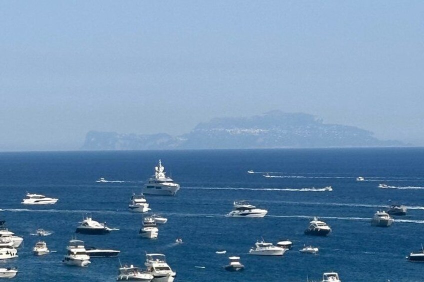 A busy marina with numerous boats docked and sailing in the water. 4