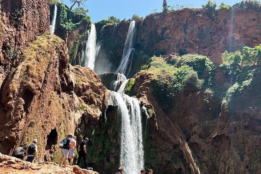 A waterfall with multiple streams cascading down a rocky cliff. 1