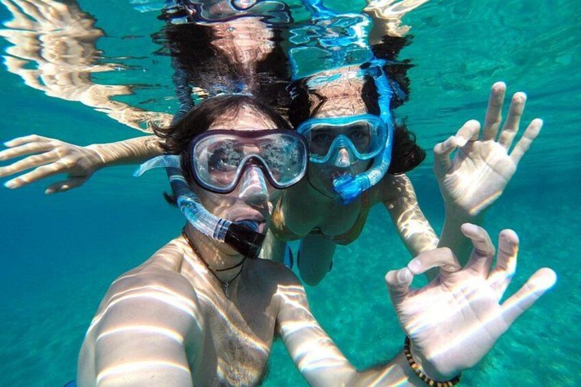 A person underwater with a snorkel and mask, reaching out with hands. 1