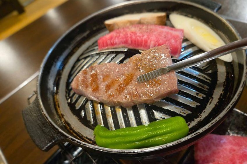 A grill with meat and vegetables. 1