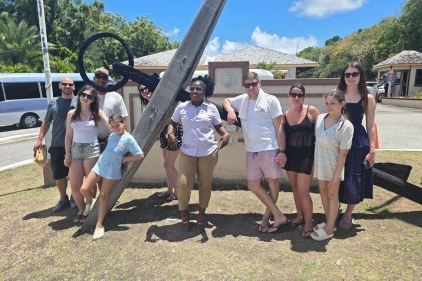 A group of people posing in front of a structure with a large ring. 5