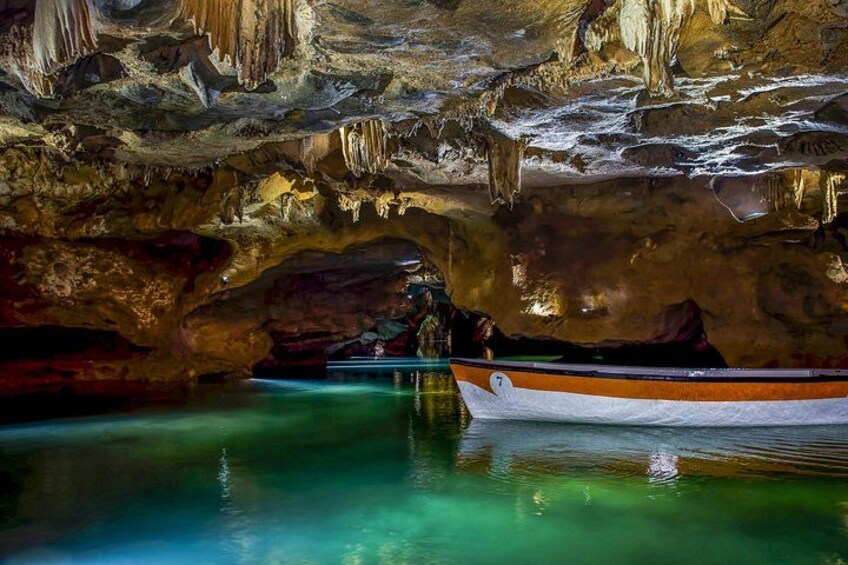 A boat in a cave with stalactites and stalagmites. 2