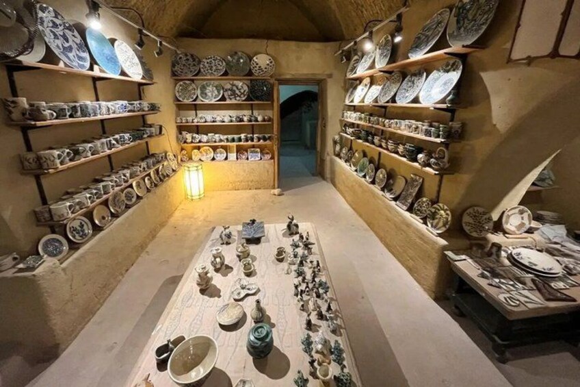 A pottery shop with shelves of ceramic plates and bowls. 5