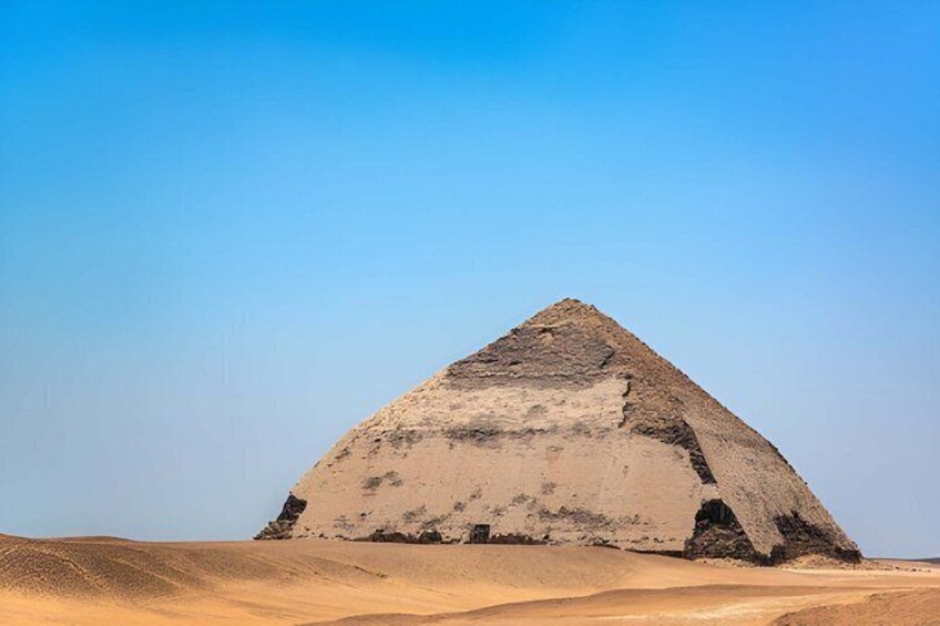 A large pyramid in a desert landscape. 3