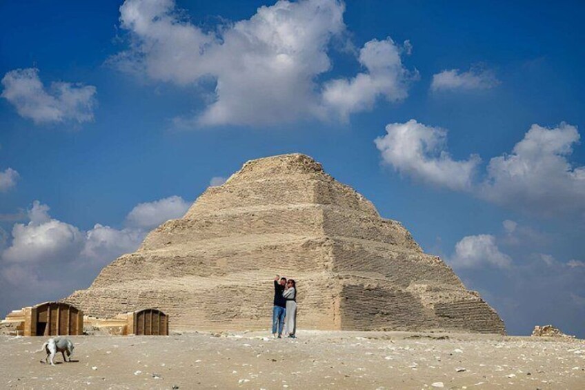 A pyramid with a person and a dog in the foreground. 1