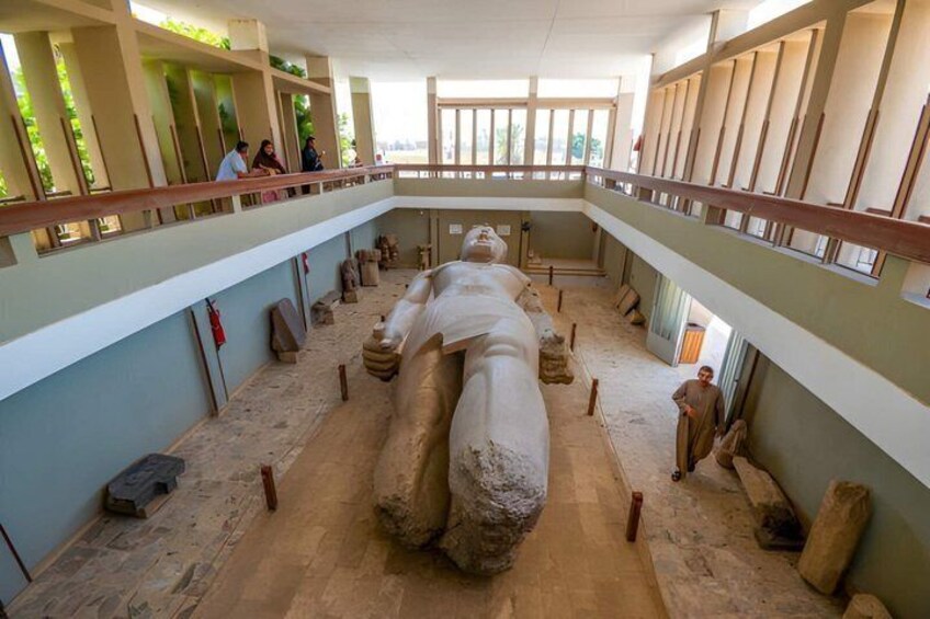 A large sarcophagus in an open-air museum with visitors around it. 2