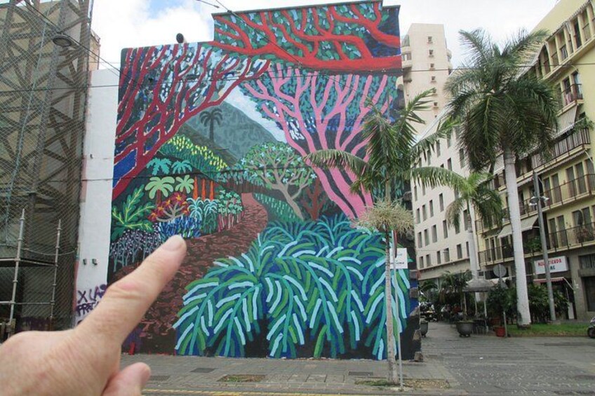 A colorful mural of a jungle scene with trees and plants. 2