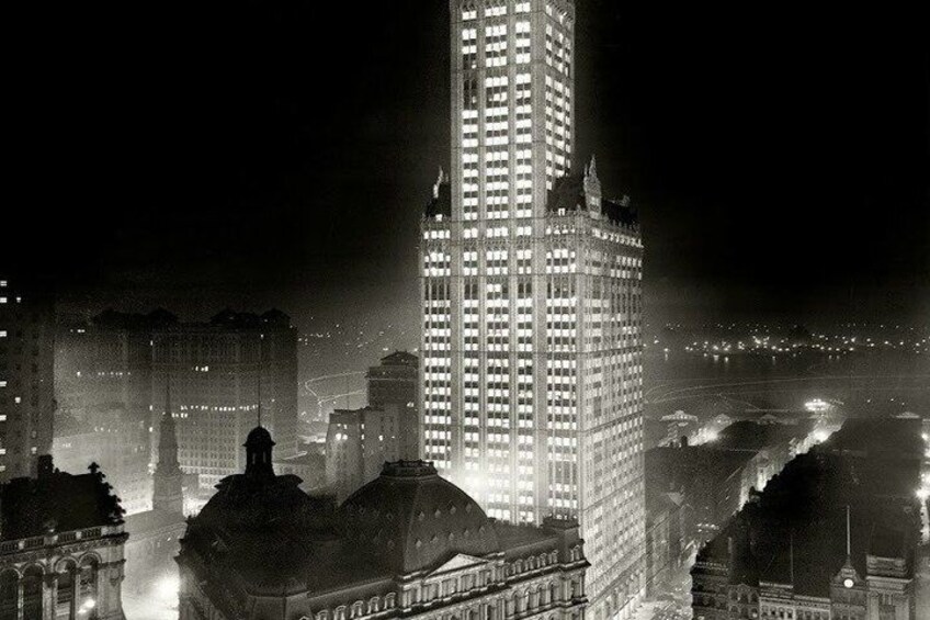 A nighttime cityscape with illuminated skyscrapers and historic buildings. 2
