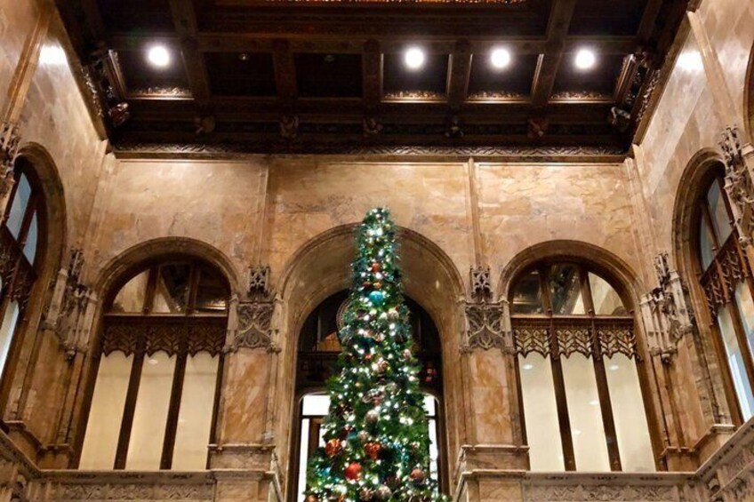 A grand arched entrance with a decorated Christmas tree. 2