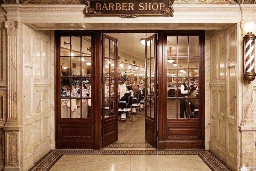 A barbershop with wooden doors and marble walls. 4