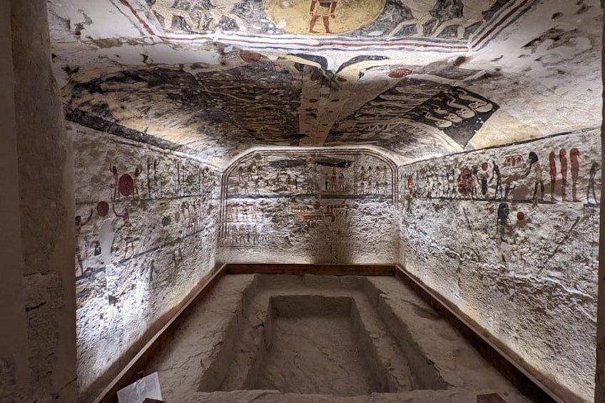 An ancient tomb with hieroglyphs and a sarcophagus. 4