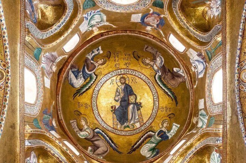 A detailed mosaic with a central figure surrounded by smaller figures, set within a golden frame. 3