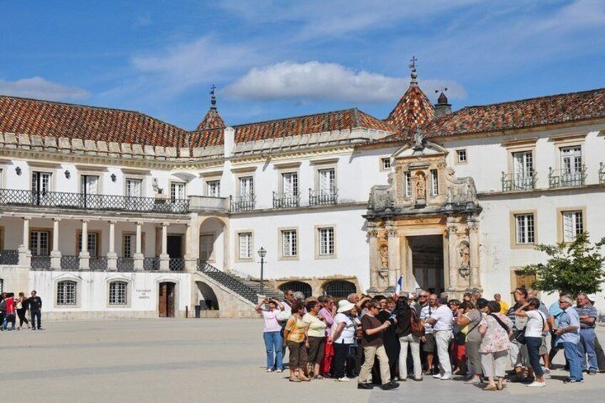 A historic building with a tiled roof and a central entrance. 1