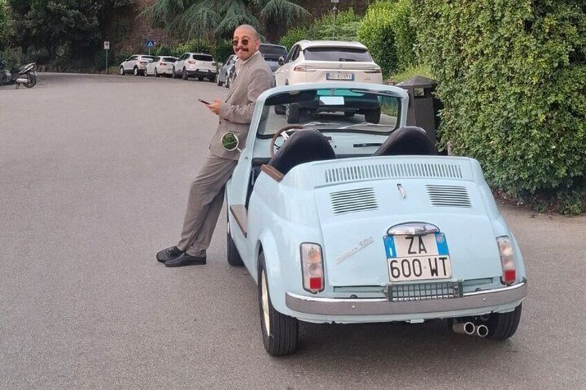 A vintage car with a license plate ZA 600 WT parked on a street. 2