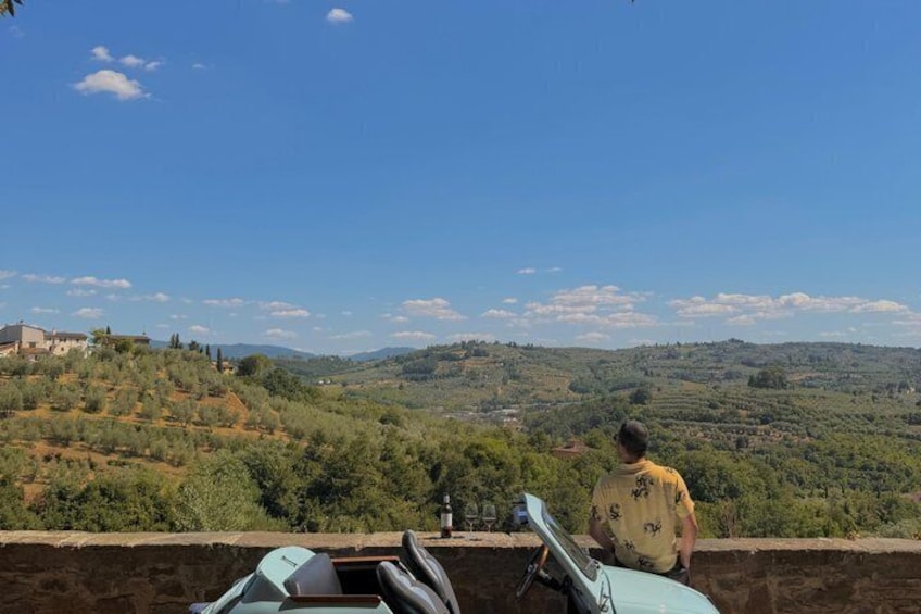 A person overlooking a hilly landscape with a clear sky. 5