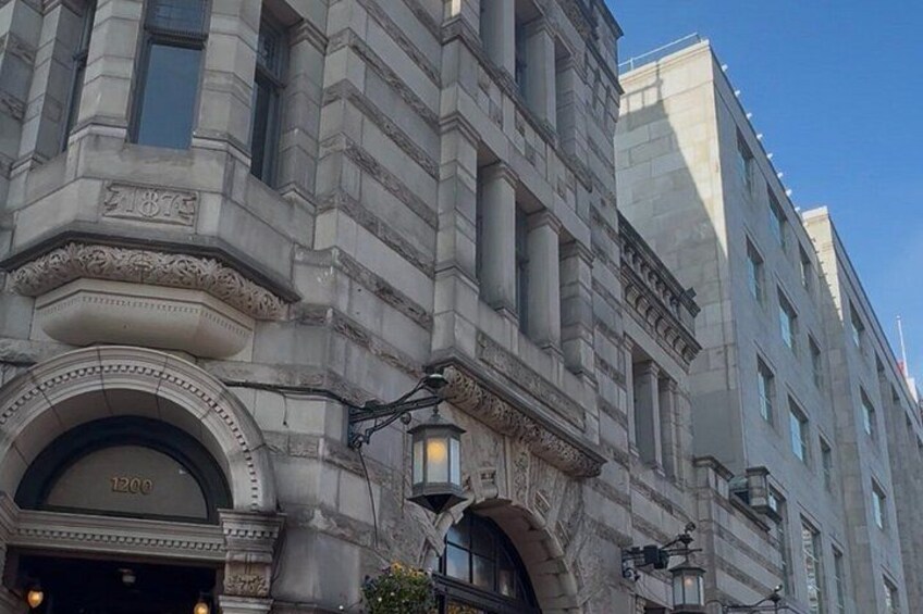 A historic building with ornate architectural details, including a large arched entrance and decorative columns. 5