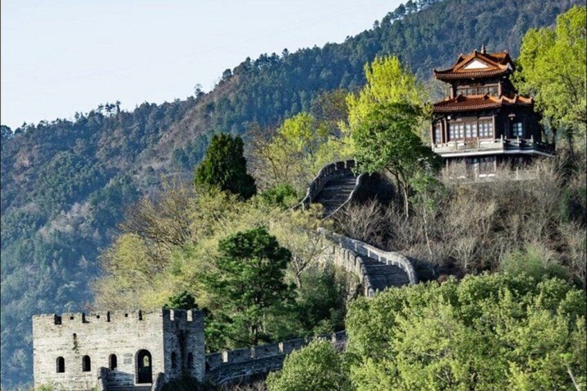 A traditional Chinese building on a hillside, a stone bridge, and a historical stone wall. 4