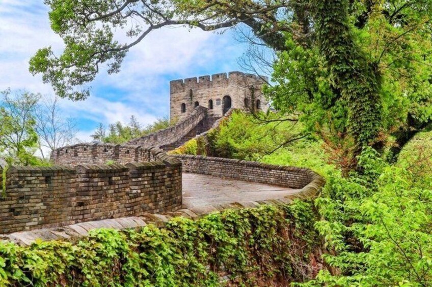 A historic stone wall and a watchtower. 1