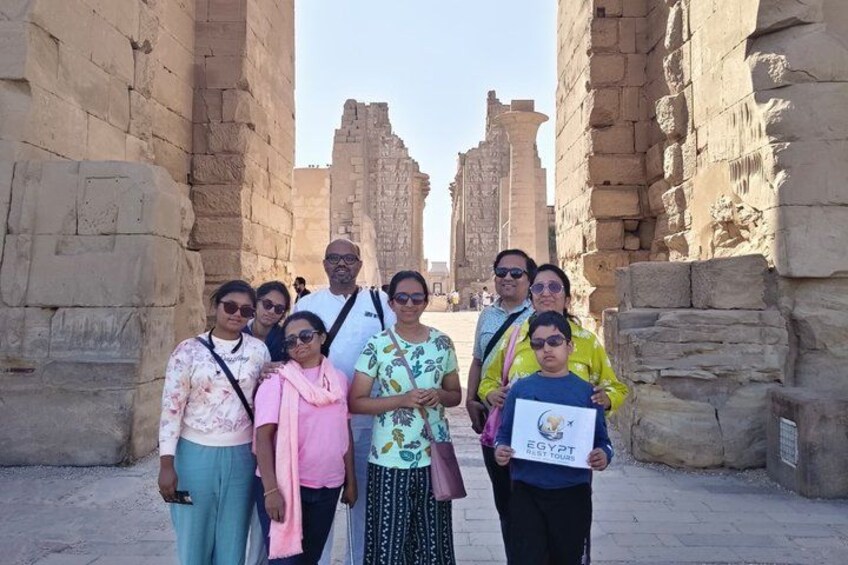 A group of people standing in front of ancient stone structures. 4